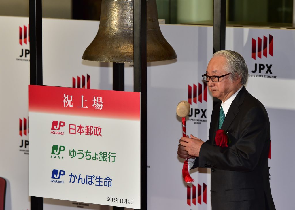 Japan Post Bank president Masatsugu Nagato rings a bell during the ceremony for the company's listing at the first sector of the Tokyo Stock Exchange on November 4, 2015. (AFP/file)