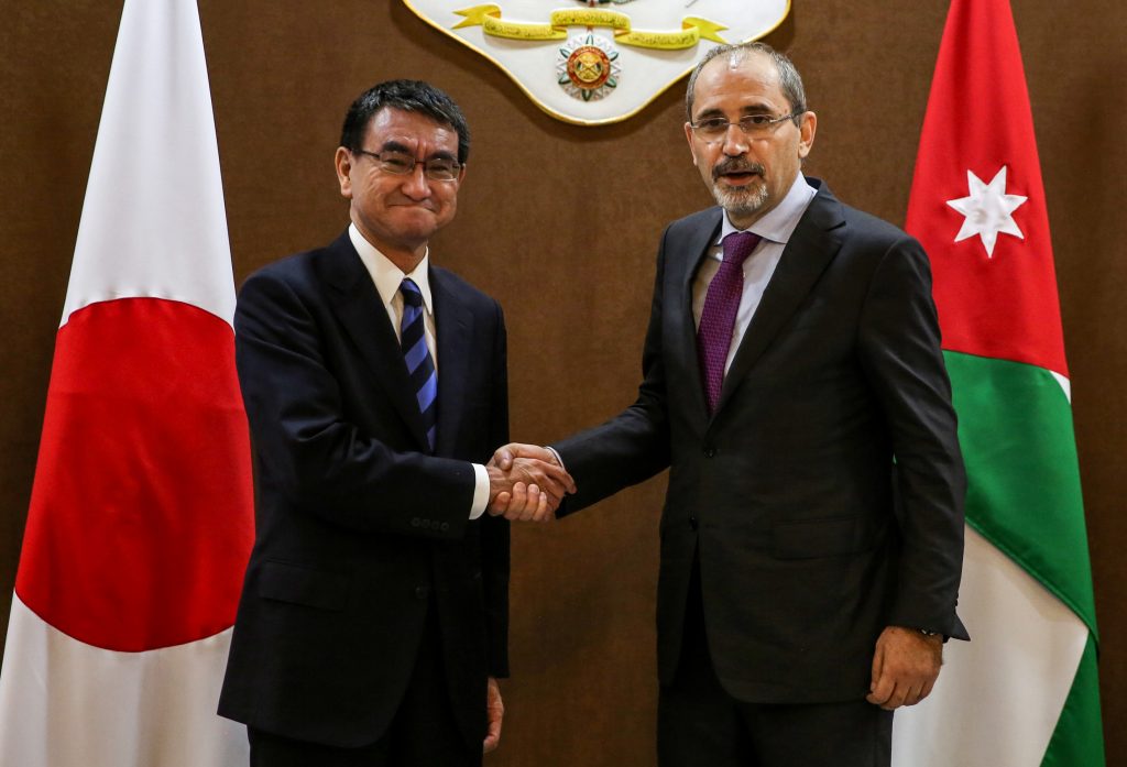 Ayman Safadi (R) shakes hands with Taro Kono in Amman on December 14, 2018. (File photo/AFP)