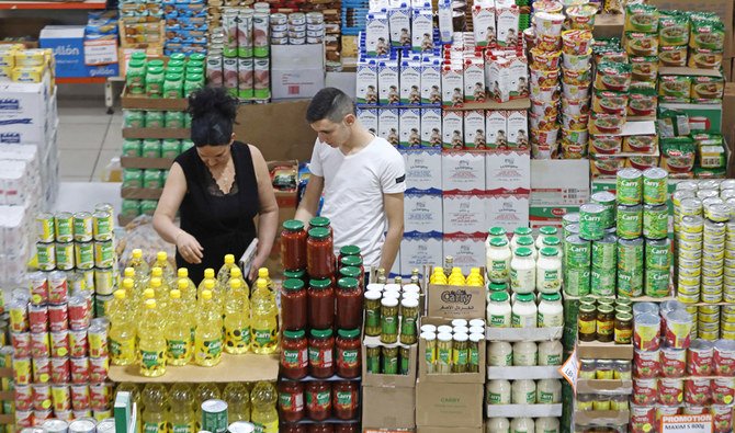 Customers at a supermarket in the wake of an economic crisis in the Lebanese capital Beirut. Many Lebanese have been forced to close shop, and a large number have been fired or seen their salaries slashed by half, even as the cost of living increases. (AFP)