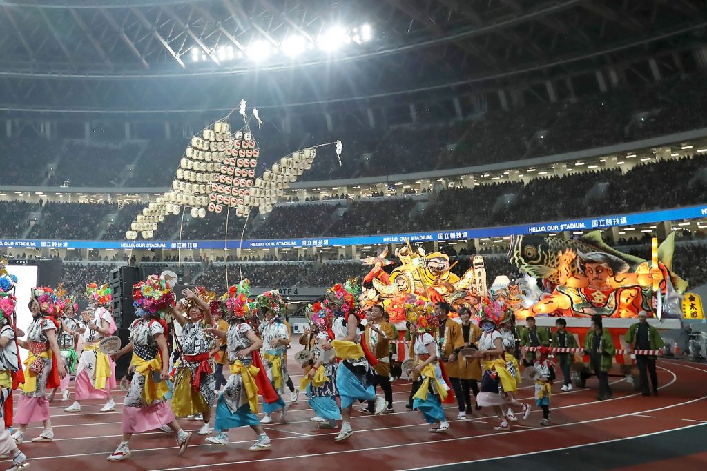 Performers participate in festival costumes of Tohoku region or Northeast Japan during the opening event for the new National Stadium, venue for the upcoming Tokyo 2020 Olympic Games, in Tokyo on December 21, 2019. (Jiji Press/AFP)