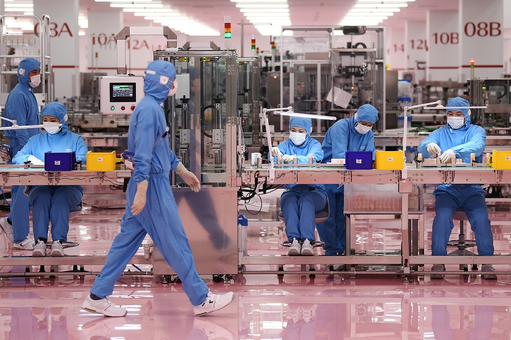 This photo taken on November 27, 2019 shows workers at the inauguration of a new production plant for Japanese cosmetics brand Shiseido in Otawara, Tochigi prefecture. (AFP/file)