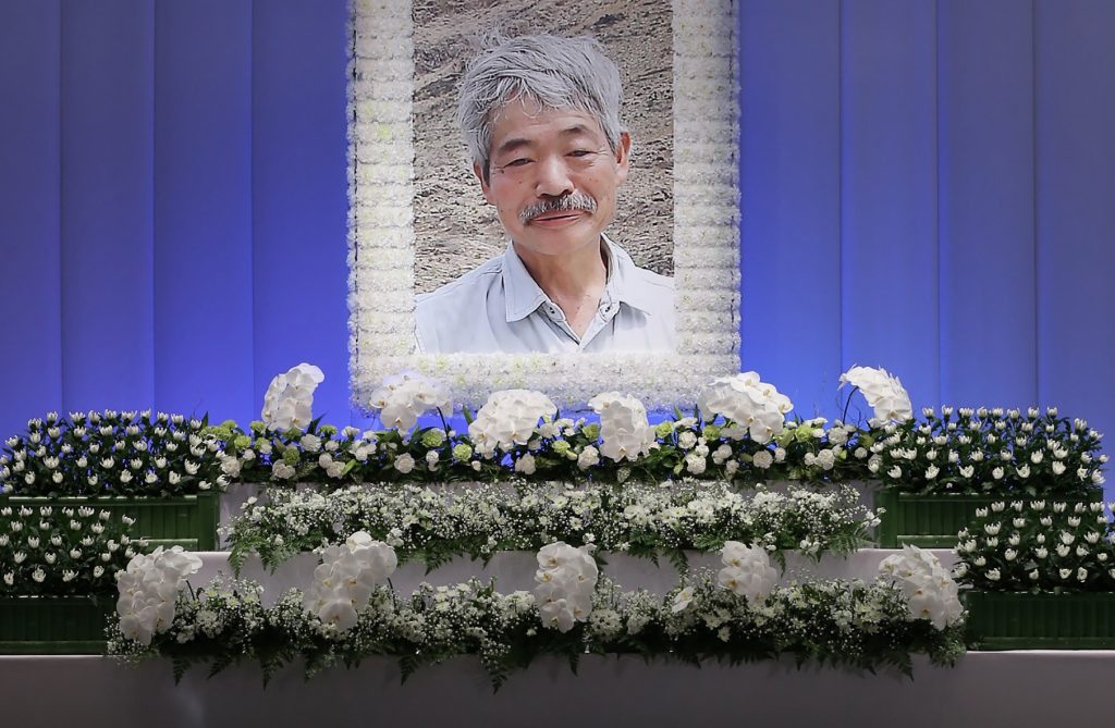 This picture shows a portrait of late Japanese doctor Tetsu Nakamura and his coffin at a funeral parlor in Fukuoka on December 11, 2019. (Jiji Press/AFP)