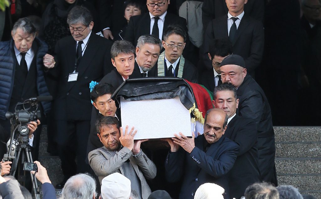 The coffin of Tetsu Nakamura is carried out from a funeral hall in Fukuoka on December 11, 2019. (Jiji Press/AFP)