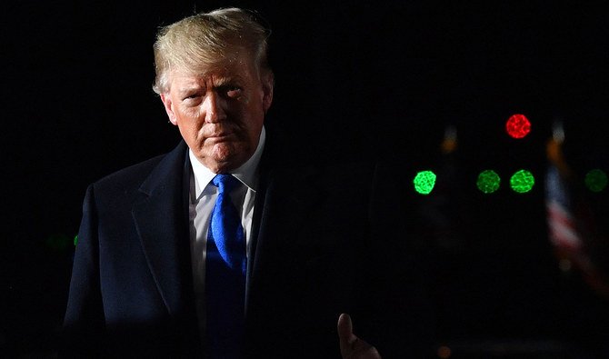 US President Donald Trump gestures after disembarking from Air Force One after landing at Stansted Airport, northeast of London. (AFP)