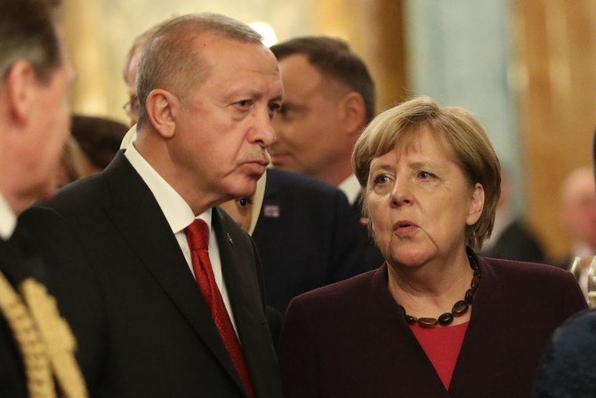 Turkey’s President Recep Tayyip Erdogan talks with German Chancellor Angela Merkel in Buckingham Palace on Tuesday ahead of the main leaders’ meeting. (AFP)