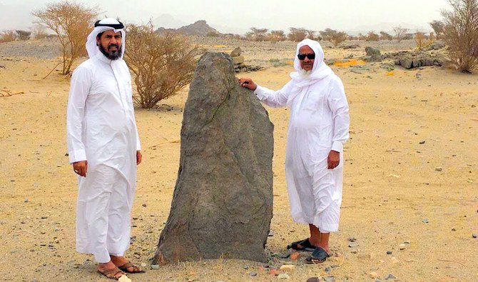 Hamdan Al-Harbi, left, with one of the stones he found. (Photo by Mohammed Al-Maghthawi)