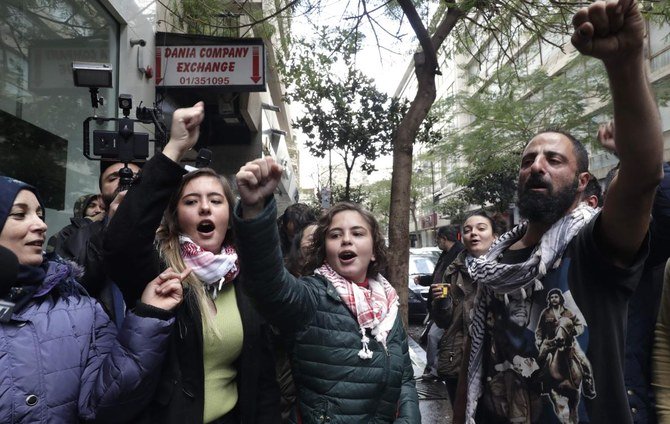 Protesters shout slogans outside a branch of BLC Bank in Beirut on Saturday, December 28, 2019 to complain against nationwide imposed restrictions on dollar withdrawals and transfers abroad. (AFP)