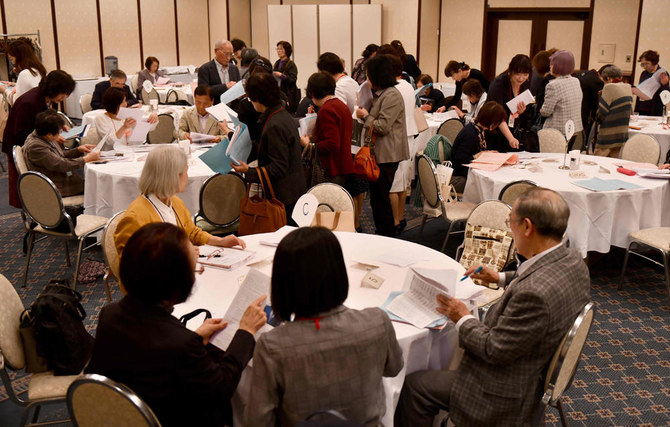 This photo taken on Nov. 3, 2019 shows a general view of parents and participants looking over information as they take part in a match-making party in Tokyo. (AFP / Toshifumi Kitamura)