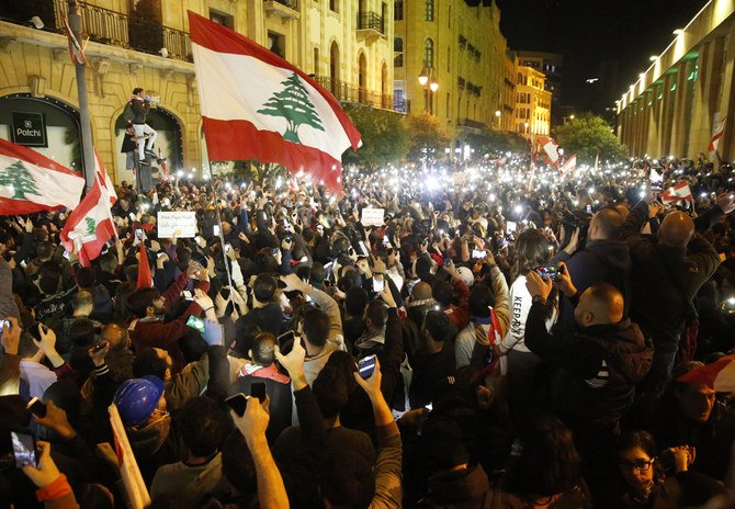 Anti-government protesters clash with the riot police, during a protest near the parliament square, in downtown Beirut, Lebanon, on Dec. 15, 2019. (AP Photo/Hussein Malla)