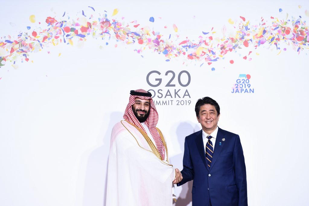Japan's Prime Minister Shinzo Abe (R) greets Saudi Arabia's Crown Prince Mohammed bin Salman during the G20 Osaka Summit in Osaka on June 28, 2019. (AFP)