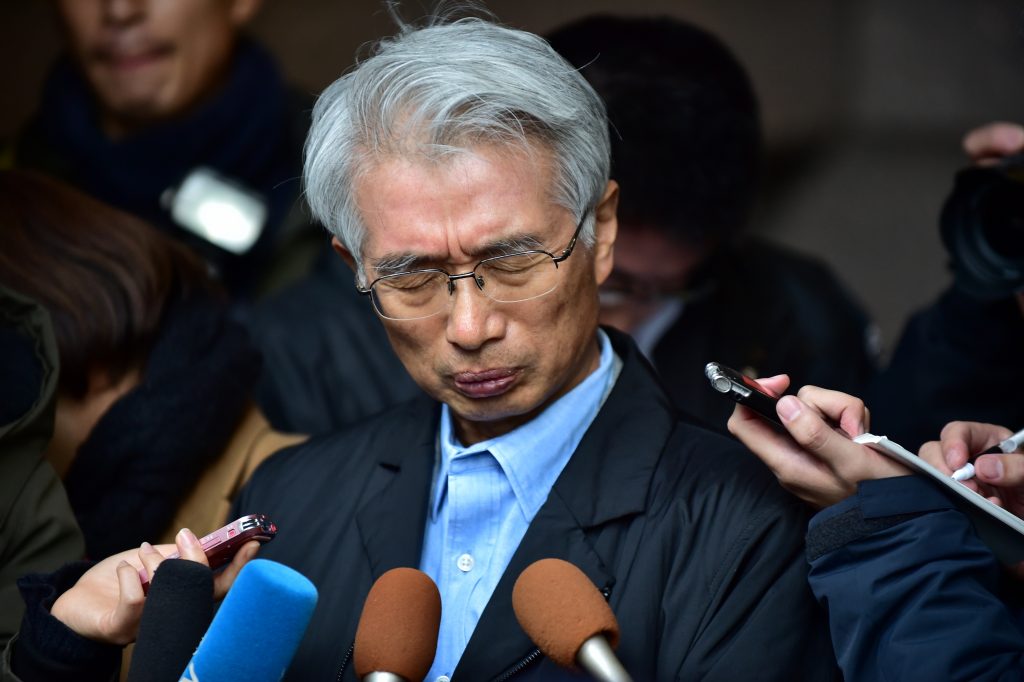Japanese lawyer for former Nissan Chairman Carlos Ghosn, Junichiro Hironaka, speaks to the media outside his office in Tokyo on Dec. 31, 2019. (AFP)