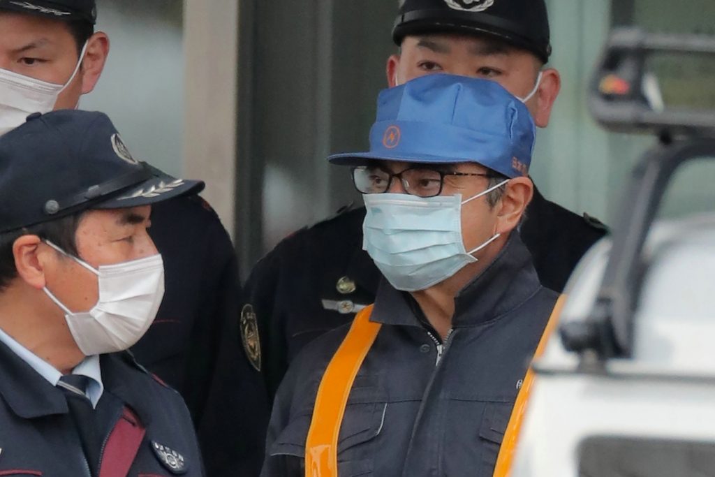 This file photo taken on March 6, 2019 shows former Nissan chairman Carlos Ghosn (R) being escorted as he walks out of the Tokyo Detention House following his release on bail in Tokyo. (AFP)