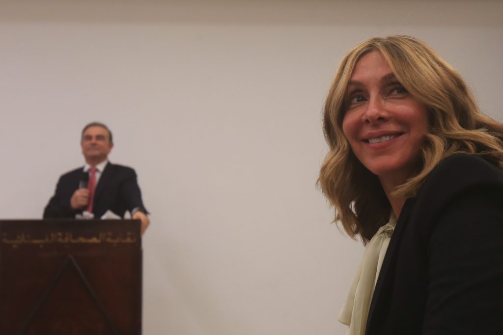 Carole, the wife of former Renault-Nissan boss Carlos Ghosn, attends a press conference in which her husband (L) addressed a large crowd of journalists on his reasons for dodging trial in Japan. (AFP)