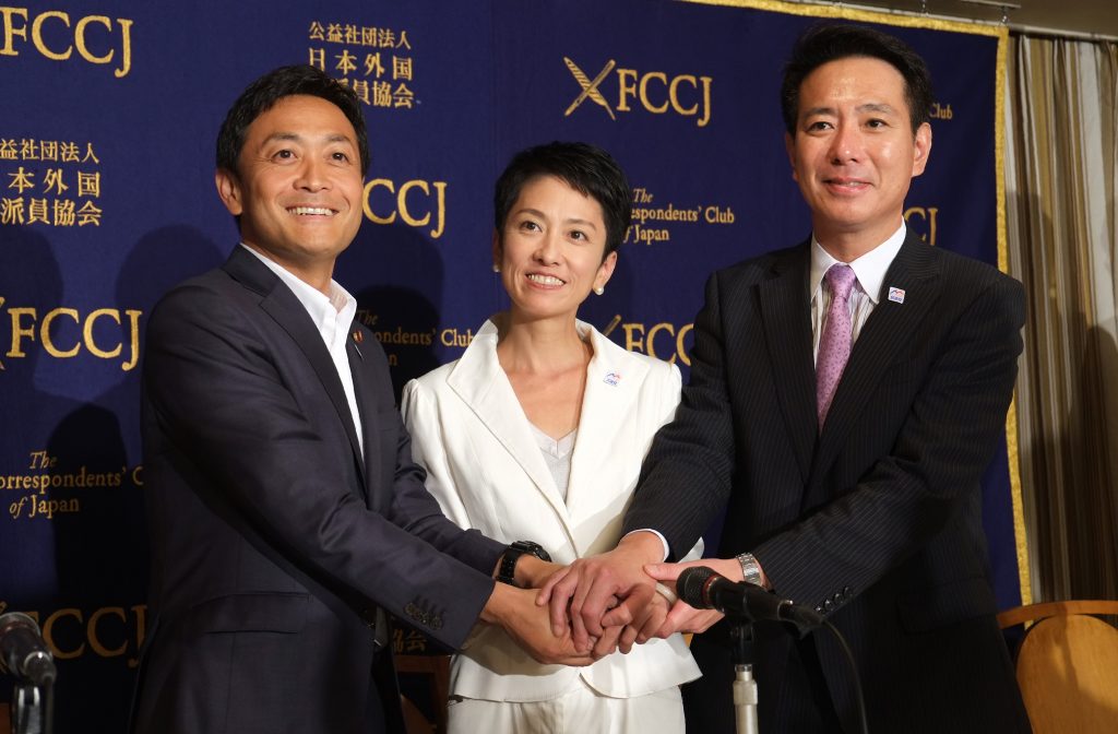 Candidates for the presidential election of Japan's Democratic Party, Seiji Maehara (R), Renho (C), and Yuichiro Tamaki (L) shake hands with each other, Sep. 13, 2016. (AFP)