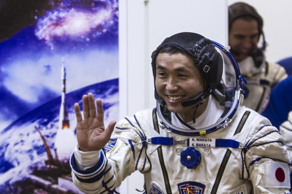 Japanese astronaut Koichi Wakata (C) smiles during a space suit test prior to blast off to the International Space Station (ISS) on Nov. 6, 2013. (AFP)