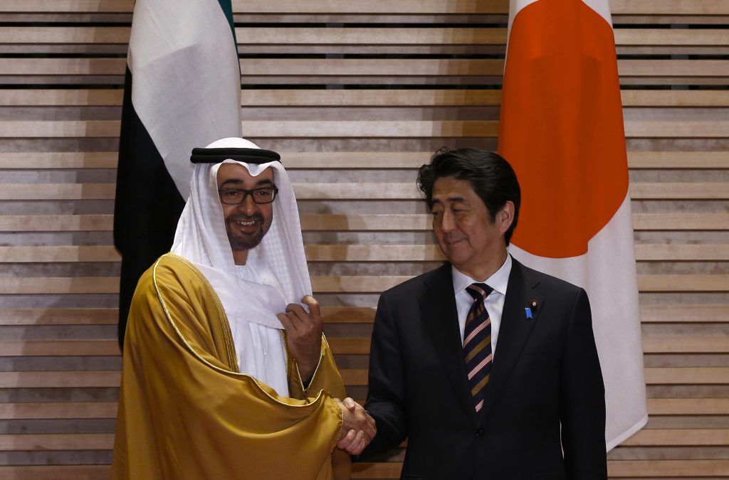 Abu Dhabi's Crown Prince Sheikh Mohammed bin Zayed al-Nahyan (L) shakes hands with Japan's Prime Minister Shinzo Abe upon his arrival at the Prime Minister's official residence in Tokyo on Feb. 26, 2014. (AFP)