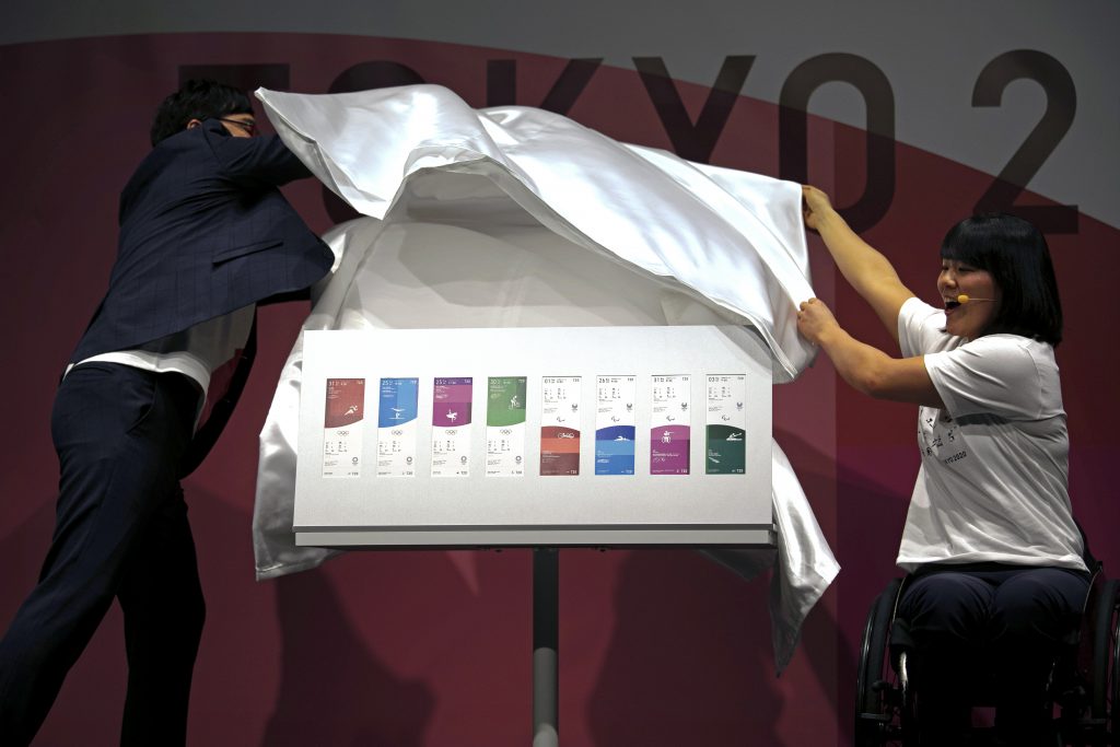 Paralympian Monika Seryu (R), and comedian Ryota Yamasato (L) unveil tickets for the Tokyo 2020 Olympics and Paralympics, Jan. 15, 2020, in Tokyo. (AP)
