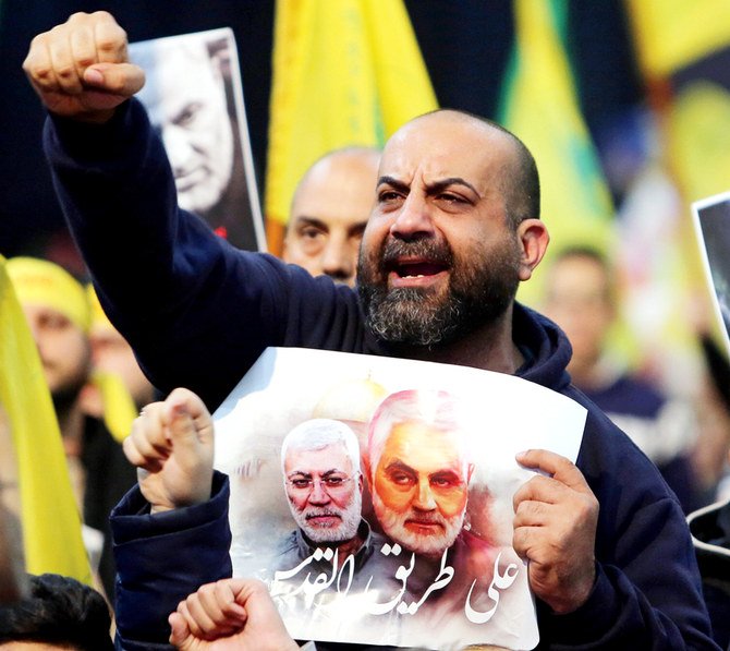 Lebanon’s Hezbollah supporters chant slogans during a funeral rally to mourn Qassem Soleimani, in Beirut’s suburbs, on Sunday. (Reuters)
