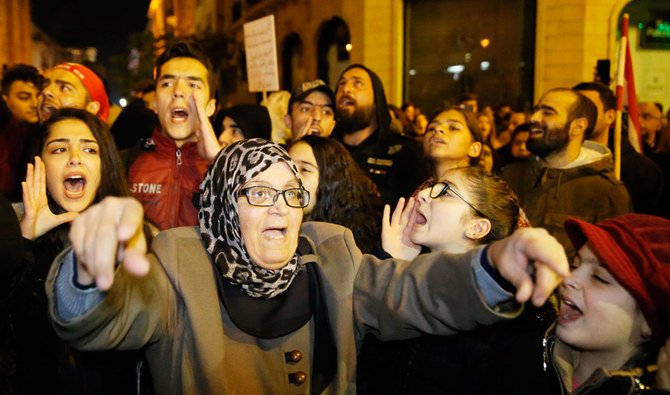 Women and children among protesters chant slogans during ongoing demonstrations against the Lebanese political class, at a road leading to the parliament building in Beirut. (AP)