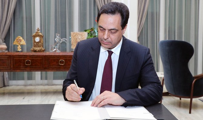 Lebanon's new Prime Minister Hassan Diab signing official documents at the presidential palace in Baabda, east of the capital Beirut. (AFP/DALATI AND NOHRA)