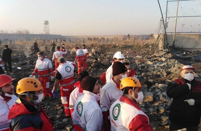 Rescue teams work at the scene after a Ukrainian plane carrying 176 passengers crashed near Imam Khomeini airport in Tehran early in the morning on January 8, 2020. (Iranian Red Crescent/AFP)