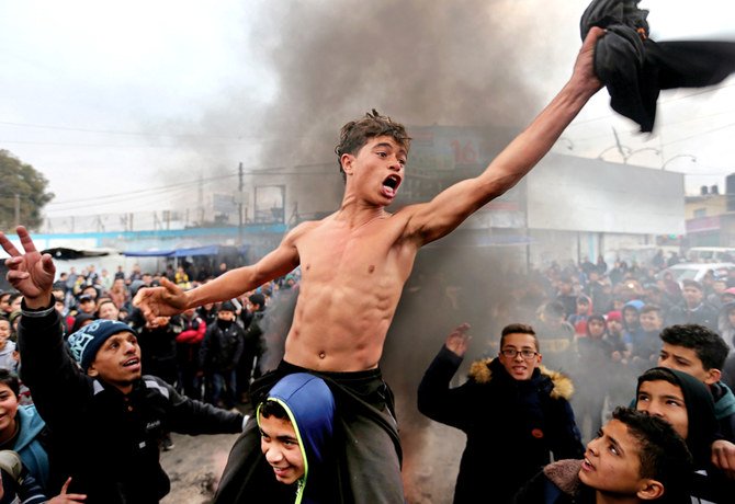 Palestinian students take part in a protest in the southern Gaza Strip, on Wednesday against the US President Donald Trump’s Middle East peace plan. (Reuters)