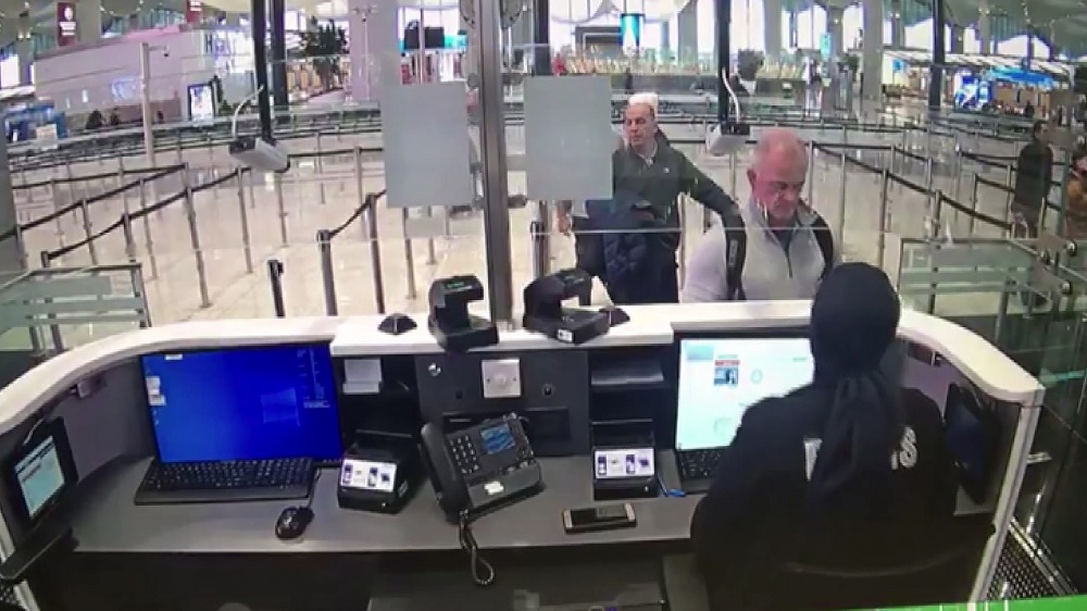 This handout video grab image released by The Istanbul Police Department on January 17, 2020, shows Michael Taylor (second right) and George Antoine Zayek (centre) at passport control in Istanbul Airport. (AFP)