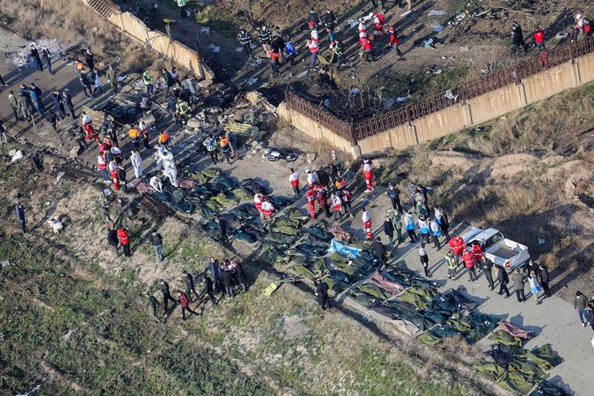 Rescue teams are pictured amid bodies and debris after a Ukrainian plane carrying 176 passengers crashed near Imam Khomeini airport early Wednesday. (AFP)