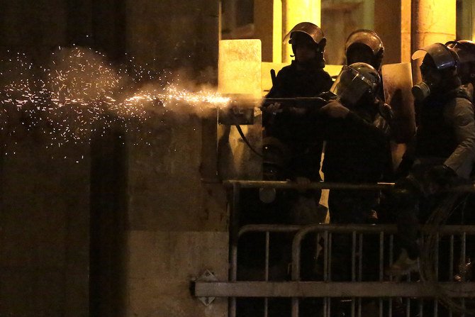 Riot police fire rubber bullets against anti-government protesters in beirut on Sunday. (AP Photo/Hassan Ammar)