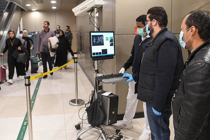 Temperature scanners are used to screen passengers for fever with upon their arrival at Kuwait international airport in Kuwait City on Wednesday, January 29, 2020. (AFP)