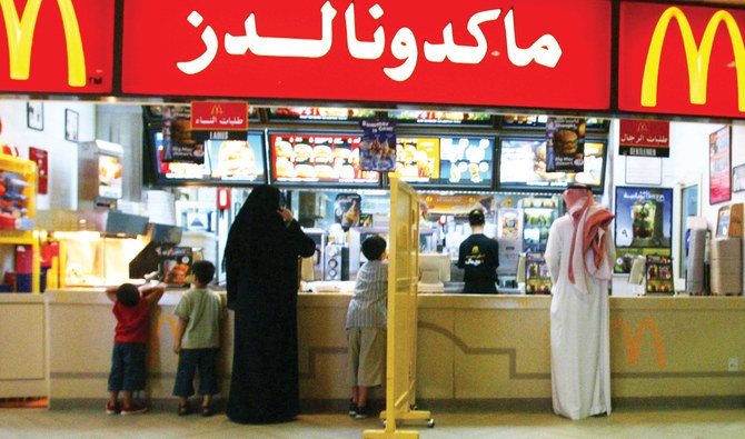 Segregation boards, such as this one pictured in a McDonald’s restaurant in Riyadh in 2004, are no longer required under Saudi law. (AFP)