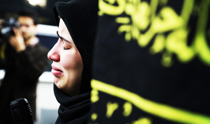 A mourner cries while speaking at a vigil at University of Toronto student housing for the victims of a Ukrainian passenger jet which crashed in Iran, in Toronto, Ontario, Canada. (Reuters)