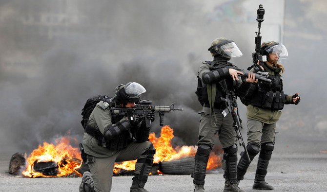 Israeli border policemen take up position during clashes with Palestinian demonstrators at a protest against Trump's decision on Jerusalem, near Ramallah, in the occupied West Bank March 9, 2018. (Reuters)