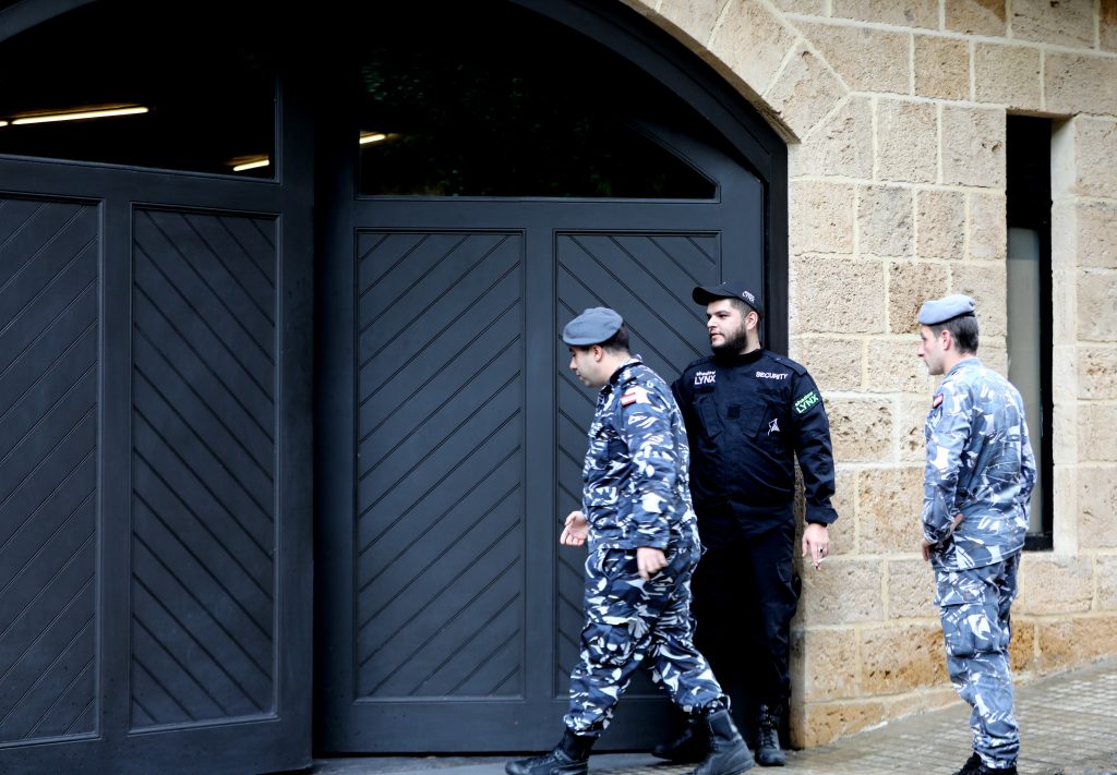Lebanese authorities stand outside a house identified by court documents as belonging to former Nissan chief Carlos Ghosn in Beirut. (AFP)