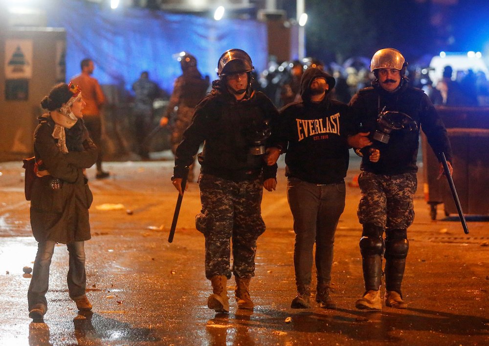 Riot police restrain a protester during a protest against a ruling elite accused of steering Lebanon toward economic crisis in Beirut, Lebanon Jan. 18, 2020. (Reuters)