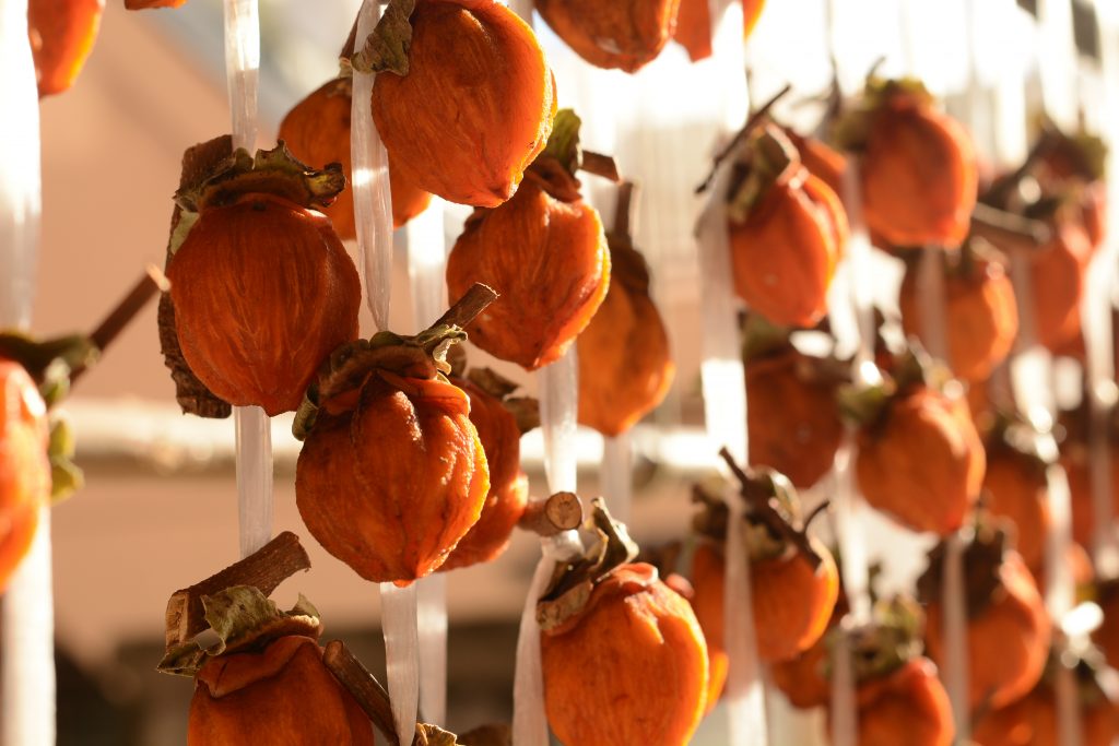 Dried persimmon, traditional Japanese fruit hanging to dry in the sun. (Shutterstock)