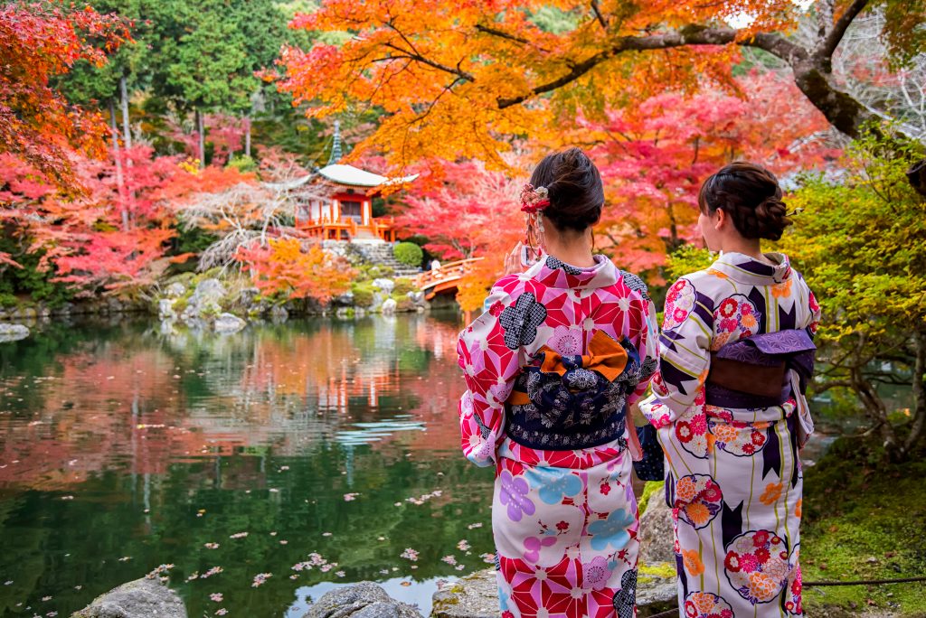 Young women wearing traditional Japanese Kimono at Daigo-ji temple with colorful maple trees in autumn, Kyoto, Japan. (Shutterstock)