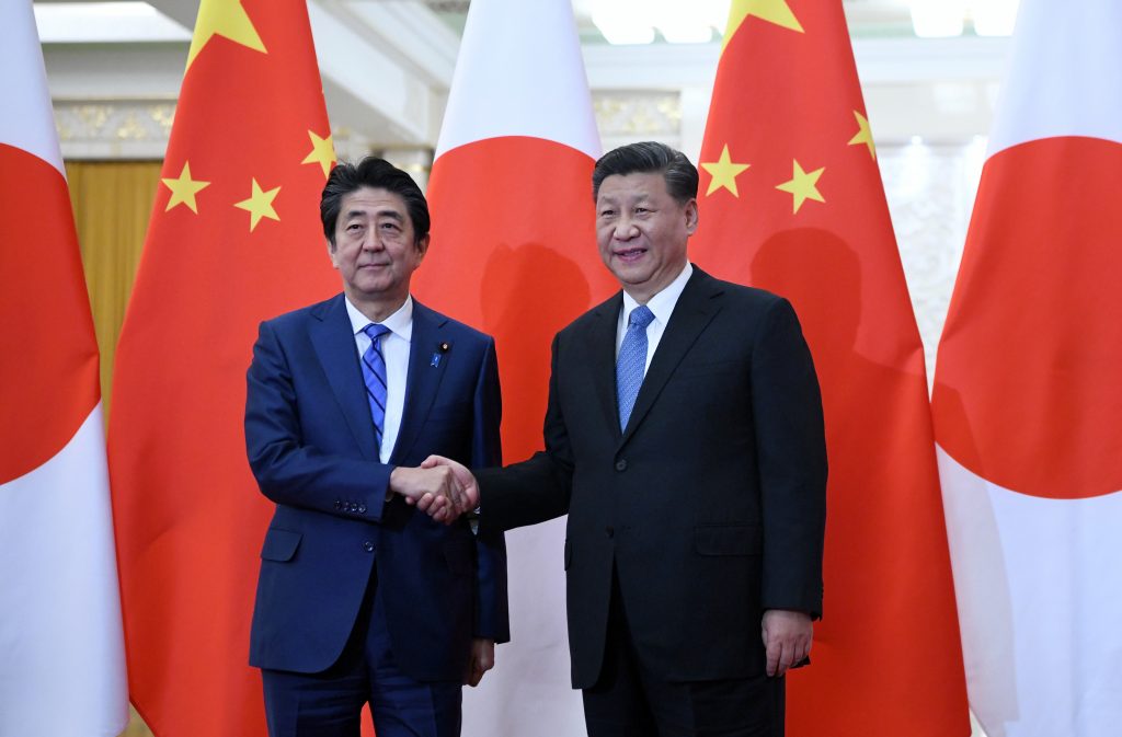 Japan's Prime Minister Shinzo Abe (L) shakes hand with China's President Xi Jinping (R at the Great Hall of the People in Beijing on Dec. 23, 2019. (AFP)