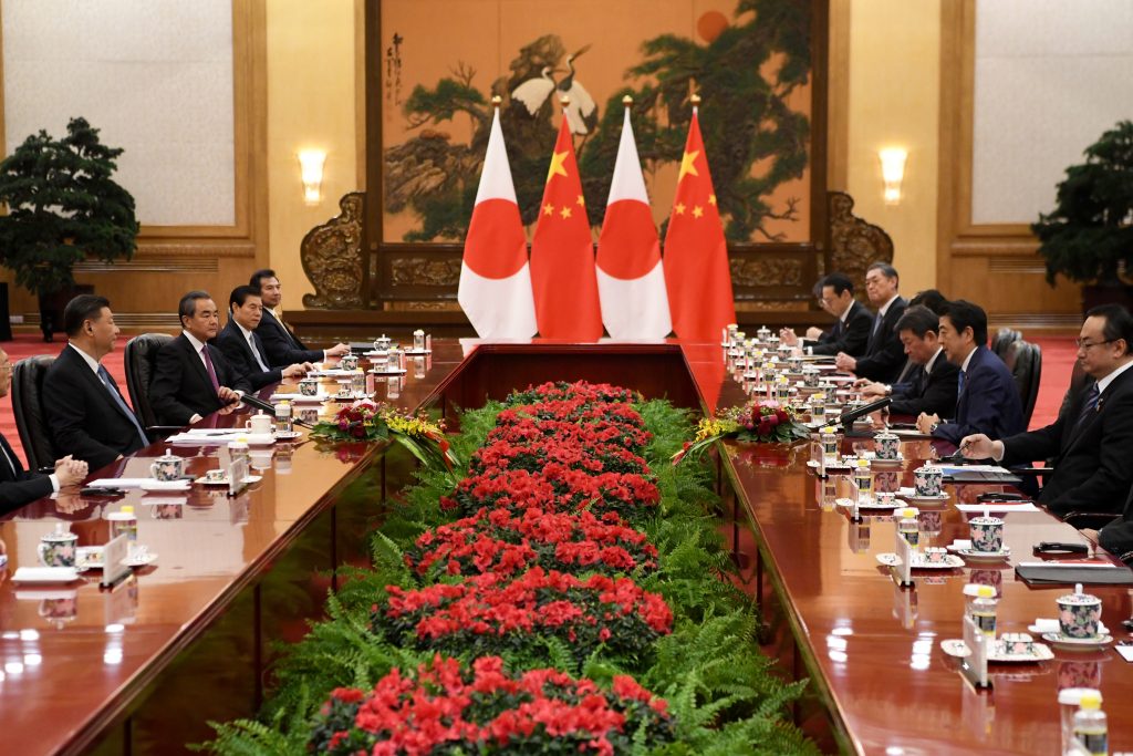 Japan’s Prime Minister Shinzo Abe (2nd R) talks to China's President Xi Jinping (2nd L) during a meeting at the Great Hall of the People in Beijing, Dec. 23, 2019. (AFP)
