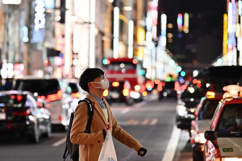 A pedestrian wearing a protective mask walks on a street in Tokyo's Ginza area, Jan. 26, 2020. (AFP)