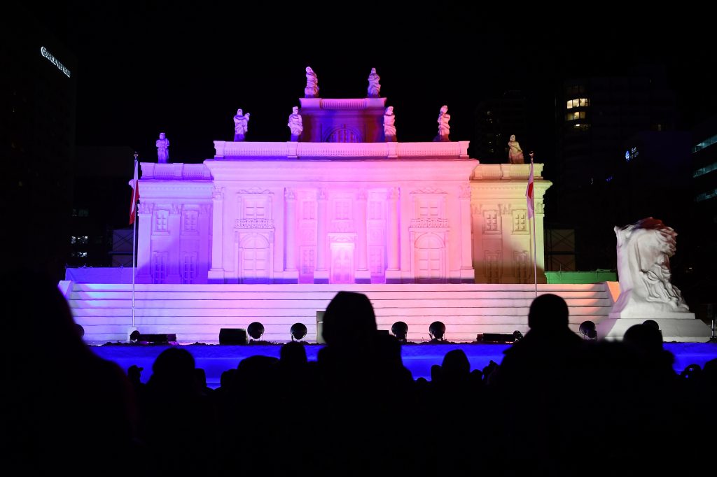 A giant snow sculpture supported by Hokkaido Broadcasting representing the Palace on the Isle in Warsaw, is seen after sundown during the Sapporo Snow Festival in Sapporo on February 4, 2020. (AFP)