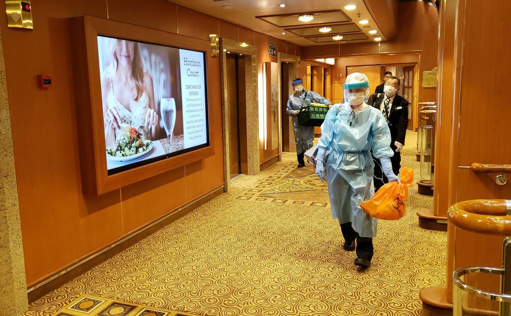 Officials in masks and protective clothing on one of the decks of the Diamond Princess cruise ship, Feb. 4, 2020. (AFP)