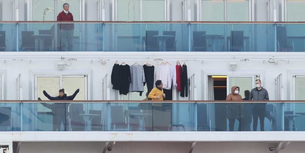 Passengers stand on balconies onboard the quarantined Diamond Princess cruise ship, Feb. 7, 2020. (Reuters)