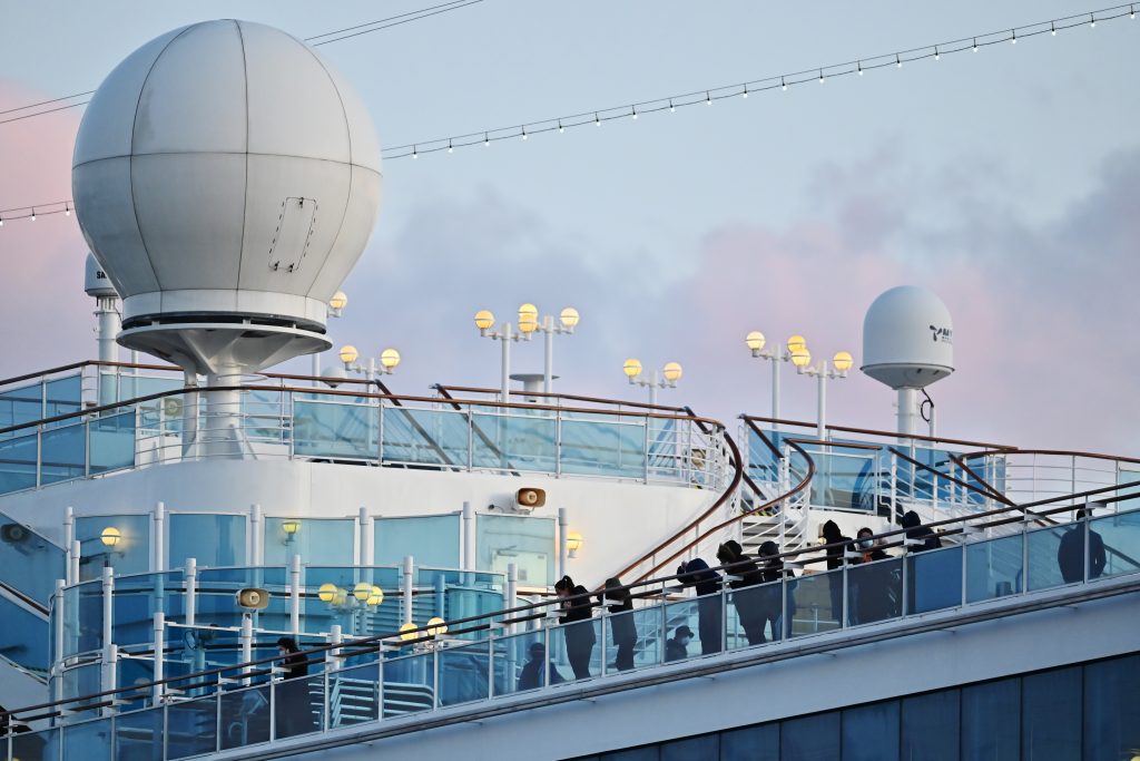 People still in quarantine due to fears of the new COVID-19 coronavirus stand on the deck of the Diamond Princess cruise ship docked at the Daikoku Pier Cruise Terminal in Yokohama on February 18, 2020. (AFP)