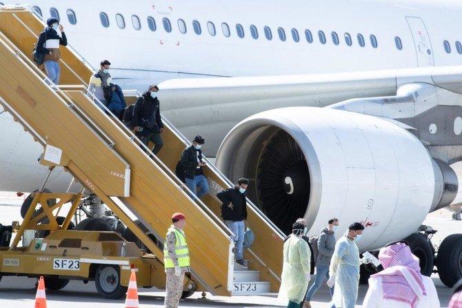 Saudi students evacuated from China's coronavirus city disembark from a Saudi Arabian Airlines plane at Riyadh's King Khalid International Airport on Feb. 2, 2020. (SPA)