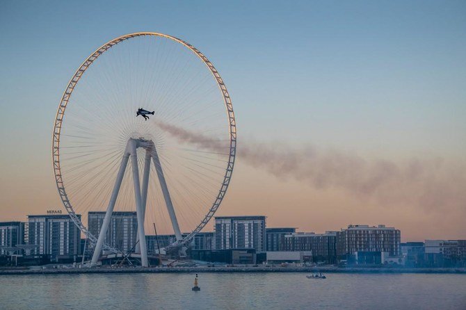Daredevil Vince Reffet hovered five meters above the crystal waters of Dubai’s coast before shooting off into the air and skimming the city’s skyline. (Expo 2020/AFP)