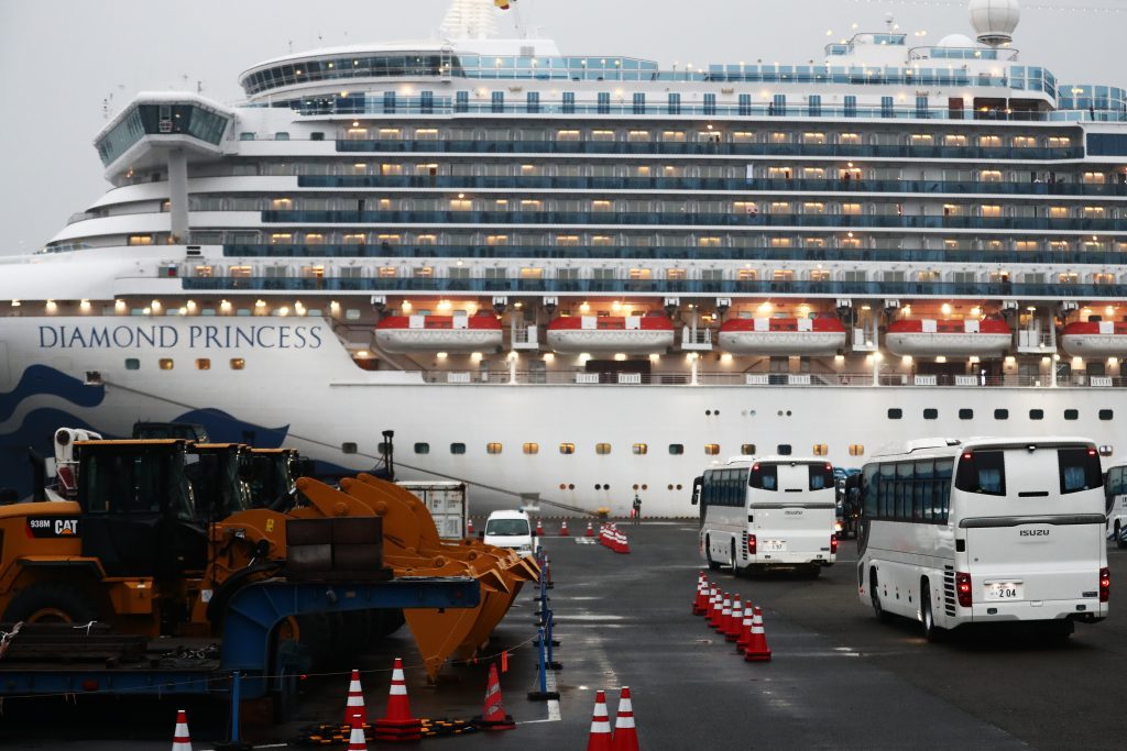 Buses next to the Diamond Princess cruise ship in Yokohama port, Japan, Feb. 16, 2020. (AFP)