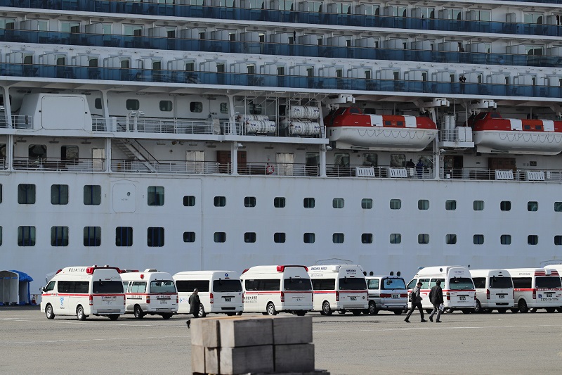 Ambulance vehicles are seen in front of the Diamond Princess cruise ship with over 3,000 people on board anchored at Yokohama port on February 7, 2020. (AFP)