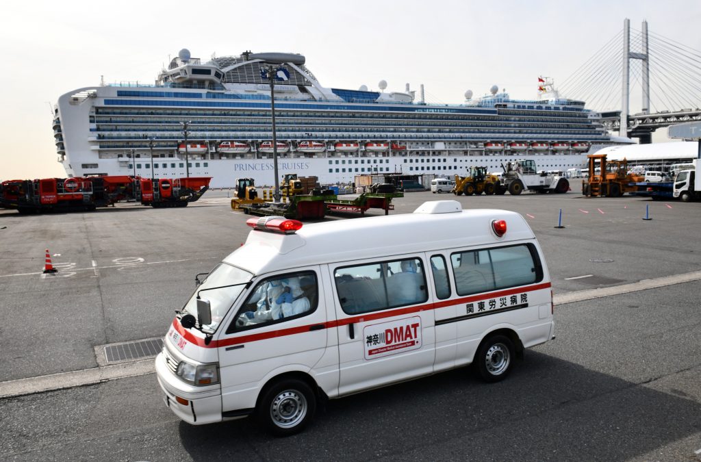 Passengers stand on balconies onboard the quarantined Diamond Princess cruise ship at Daikoku Pier Cruise Terminal in Yokohama on Feb. 7, 2020. (AFP)