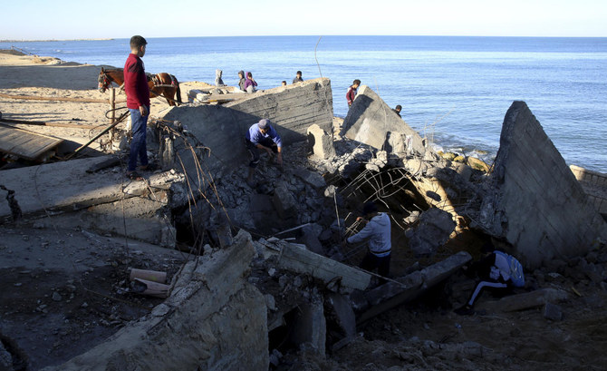 Residents inspect destroyed sewage pipes following overnight Israeli missile strikes along the beach of Shati refugee camp, in Gaza City, Thursday, Feb. 6, 2020. (AP)